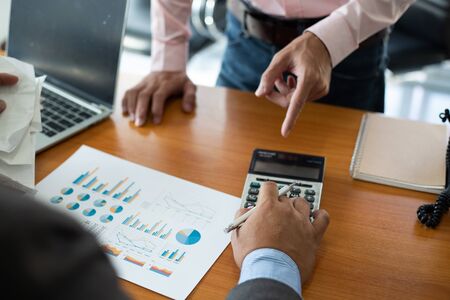 business man using calculator and holding bill for calculate tax in office.