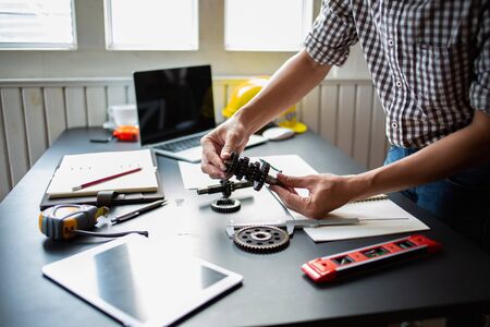 Engineering is checking the metal wheel for future car assembly.の写真素材