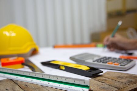 Architect Designing in blueprint at Construction Site With drawing equipment.concept