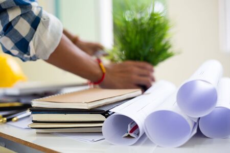 architect man handwriting with blueprint to build houses. After agreeing the employment price the...