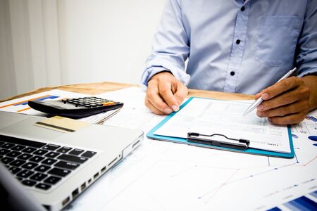 Hand business Writing tax on desk about at home office