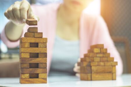 Business women are sitting in the office building construction model to work in the future.の写真素材