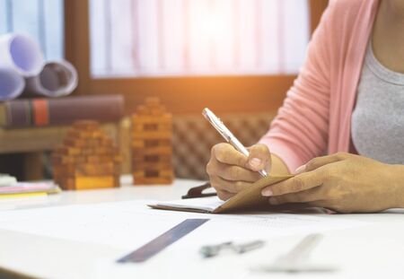Business women are sitting writing future office building projects.