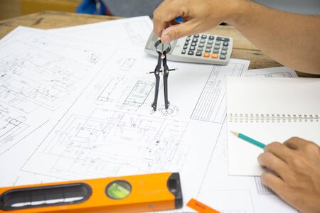 Architect Designing in blueprint at Construction Site With drawing equipment.concept