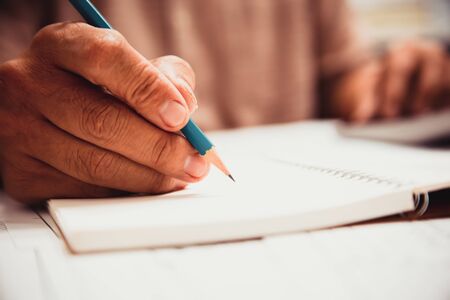 Businessman hand writing with document at work office