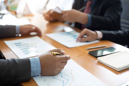 Closeup hand team business analysts make decisions about the US economy that affect future...
