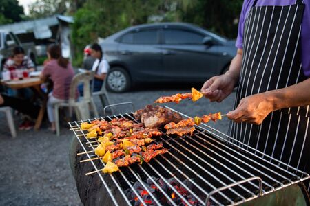 Barbeque Grill Street Food in thailand,Eat outdoors in a happy family. holiday celebration conceptの写真素材