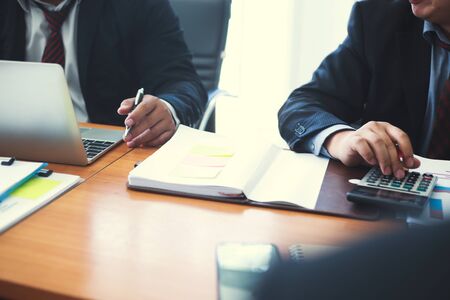 Business managers are analyzing and presenting results to the team to plan future work.の写真素材