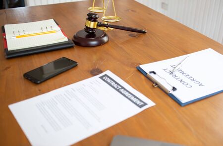Justice law Scales and books and wooden gavel tool on desk in  Lawyer office.conceptの写真素材