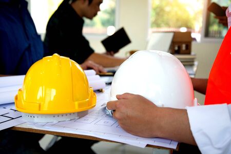 Team work Engineers join hands to agree on a residential construction project.concept