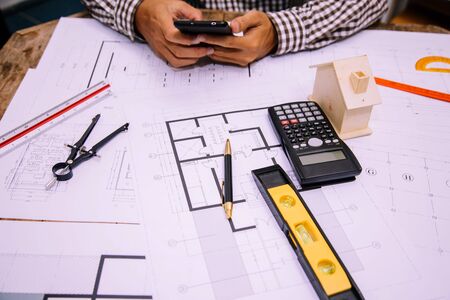 Engineers are searching for information on design and construction for future home building projects.の写真素材