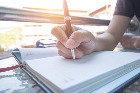 Businessman hand writing at document. Closeup.project concept.の写真素材