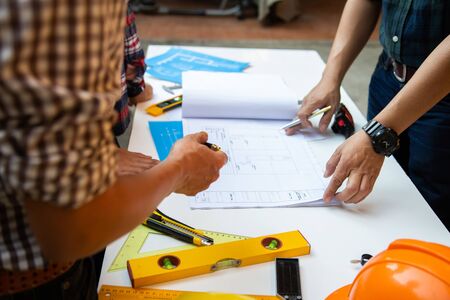 Architect group Present a job to the management. with blueprints in the office