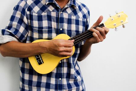 A man playing ukulele on White backgroundの写真素材