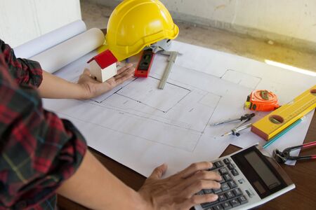 team Engineer and Architect consult projct with blueprint  at Construction Site