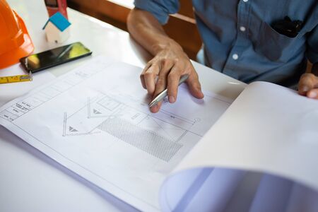Architect Inspect the project design with blueprints in the office.concept