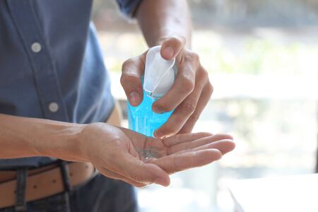 Men pressing gel bottles to wash hands to prevent respiratory diseases