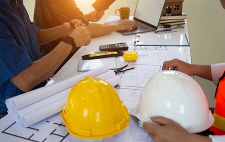 Team work Engineers join hands to agree on a residential construction project.concept