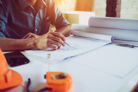 Concept architects equipment project on the desk with  blueprint in construction site.Selective...