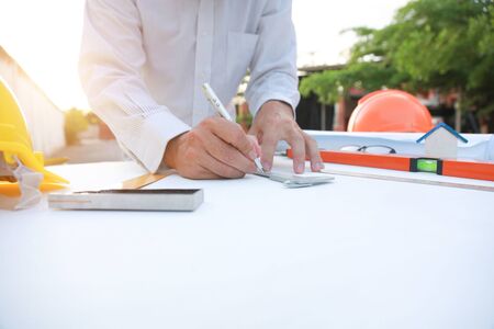 Engineer and Architect drawings blueprint  at Construction Siteの写真素材