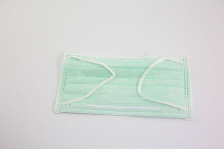 Dust mask and Covid 19 protection, placed on a white backgroundの写真素材