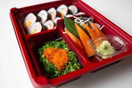 Japanese food put in a box placed on a white tableの写真素材