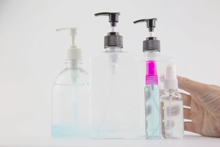 man's hand was pressing a bottle of alcohol to wash his hands to prevent Kovid 19 on a white background.の写真素材