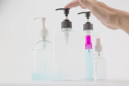 man's hand was pressing a bottle of alcohol to wash his hands to prevent Kovid 19 on a white background.の写真素材
