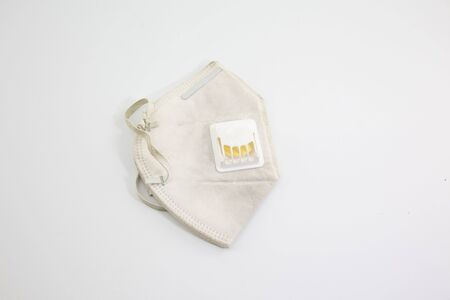 Dust mask and Covid 19 protection, placed on a white backgroundの写真素材