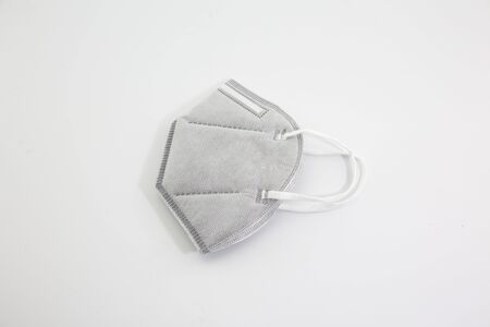 Dust mask and Covid 19 protection, placed on a white backgroundの写真素材
