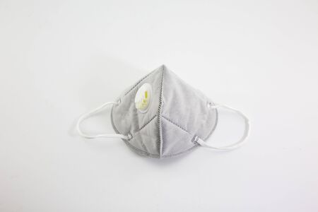 Dust mask and Covid 19 protection, placed on a white backgroundの写真素材