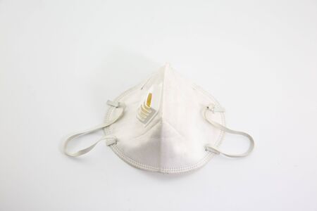 Dust mask and Covid 19 protection, placed on a white backgroundの写真素材