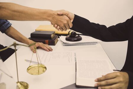 lawyer is currently shaking hands to agree on the success of winning the business case.の写真素材