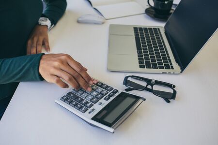 business team hands searching for data on mobile phone  with analyzing charts at his workplace.の写真素材