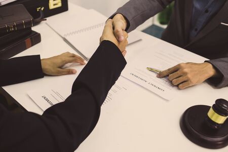 lawyer is currently shaking hands to agree on the success of winning the business case.