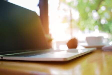 notebook was placed on a table by the window for doing business online at home during the outbreak of the Covid outbreak.の写真素材