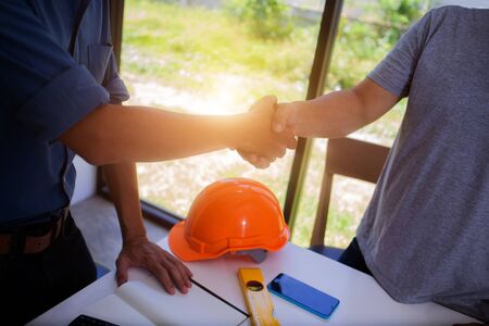 Engineers are handshake with architects to agree on a residential construction project.conceptの写真素材