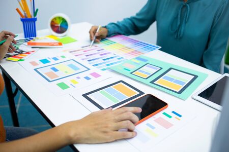 designers are testing the mobile phone screen to suit their usage.UX UI and Programming development conceptの写真素材