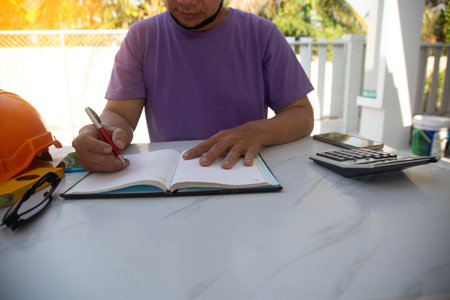 Architect or engineer working on blueprint at construction site. Construction concept.の写真素材