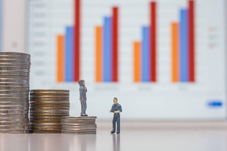 Miniature people engineer standing on coins, Success people miniature businessの写真素材