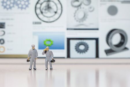 Miniature people engineer standing on coins, Success people miniature business