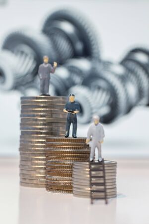 Miniature people engineer standing on coins, Success people miniature businessの写真素材