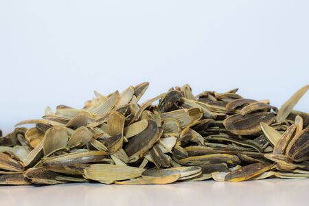 A pile of sunflower seeds on the white tableの写真素材