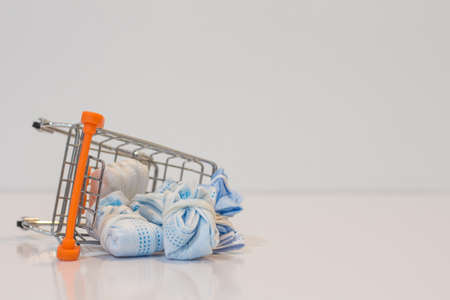 Close-up medical mask protection virus on mini shopping cart on white background  with copy specs