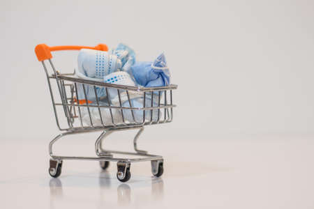 Close-up medical mask protection virus on mini shopping cart on white background  with copy specsの写真素材