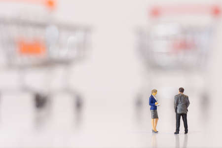 Miniature people : Business men stand and look at the used medical maskの写真素材