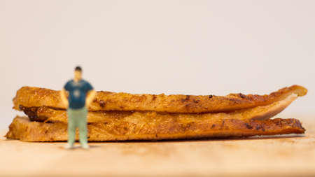 Miniature people, Close up fat man with grilled pork neck on white background with copy space