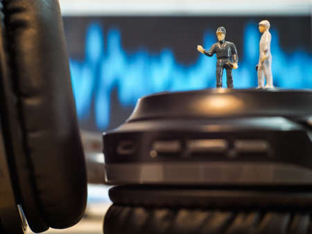 Miniature people : Close up engineer checks the sound quality of the headphone
