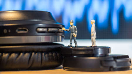 Miniature people : Close up engineer checks the sound quality of the headphone