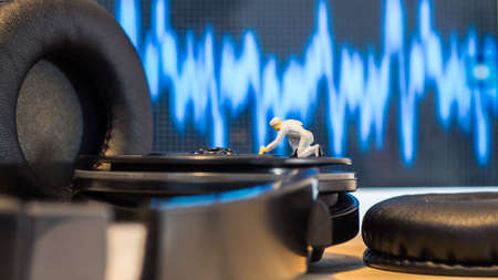 Miniature people : Close up engineer checks the sound quality of the headphone